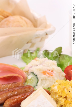 Morning breakfast Camembert cheese wiener scrambled eggs salad bread bright background Morning breakfast Camembert cheese wiener scrambled eggs salad bread bright background 104200735