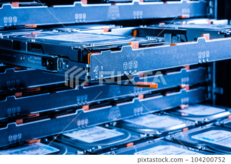 close up of hard disk drives inside hosting center - server rack filled with trays full of data storage drives close up of hard disk drives inside hosting center - server rack filled with trays full of data storage drives 104200752
