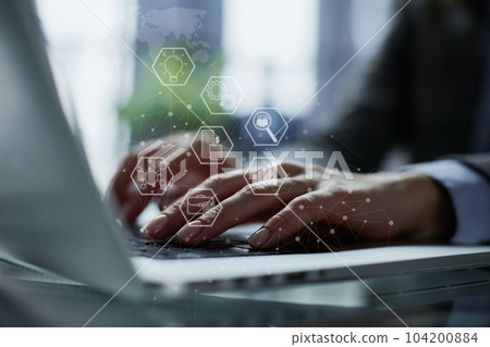 Close-up of male hands using laptop at office 104200884