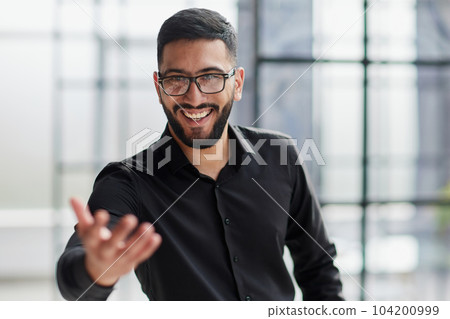 Businessman ready to shake hand in office Businessman ready to shake hand in office 104200999