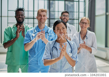 Professional multinational doctors applauding in front of the camera. Diagnostic discussion Professional multinational doctors applauding in front of the camera. Diagnostic discussion 104201001