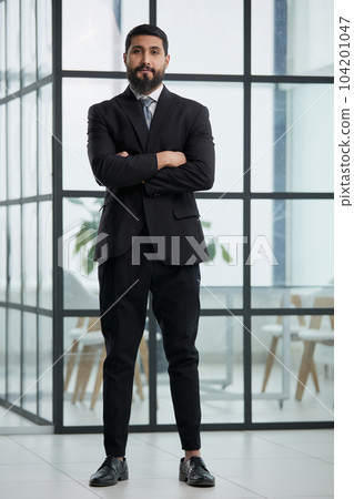Portrait of successful businessman standing in office Portrait of successful businessman standing in office 104201047