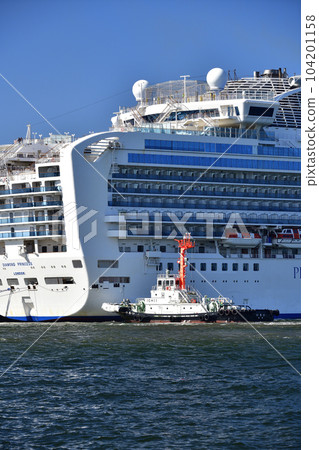 Photographing the scenery of a tug boat docking the cruise ship Diamond Princess at Hakodate Port in Hakodate City, Hokkaido in early summer 104201158