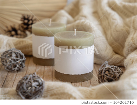 Candles with blank label near natural wooden decorations, Close up, copy space, mock up 104201710