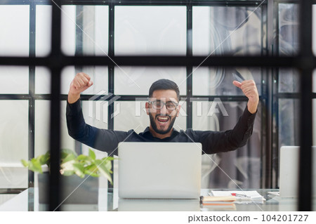 Business man sitting at his desk in the office Business man sitting at his desk in the office 104201727