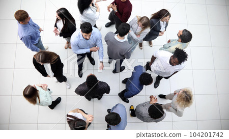 office workers and foreign employees stand and talk in the office lobby.Top view. 104201742