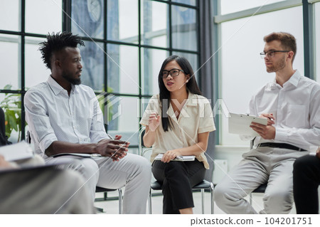 colleagues discussing possible questions for speakers before political summit in conference hall 104201751