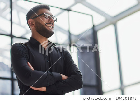 Portrait of smiling young businessman in office 104201875