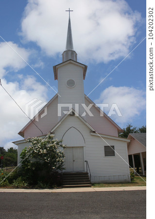 Small White Historical Church With Blue Sky on Summer Day 104202302