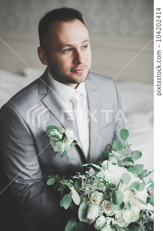Beautiful man, groom posing and preparing for wedding 104202414