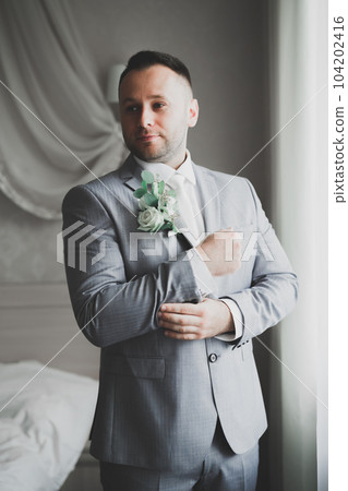 Beautiful man, groom posing and preparing for wedding 104202416