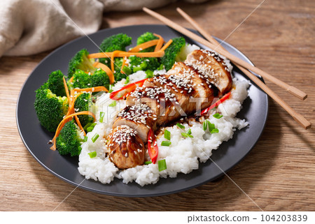 Plate of teriyaki chicken with vegetables and rice 104203839