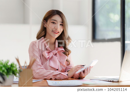 Smiling Asian Accountant person analyze financial report and studies annual figures, analyzes profits Smiling Asian Accountant person analyze financial report and studies annual figures, analyzes profits 104205114