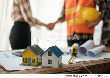 Close-up image of an engineer shaking hands with his coworker during the meeting. teamwork, building trust, unity 104205527