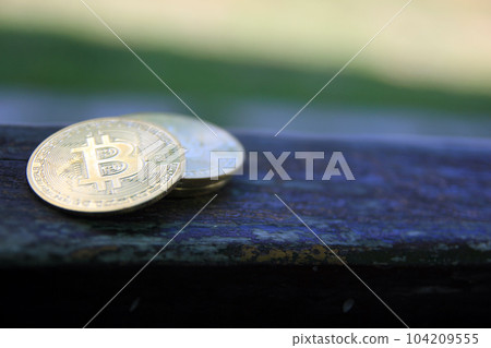 Bitcoin gold coin on wooden table with natural background, Bitcoin coin business concept. Bitcoin cryptocurrency. Bitcoin coin electronic money model. Bitcoin gold coin on wooden table with natural background, Bitcoin coin business concept. Bitcoin cryptocurrency. Bitcoin coin electronic money model. 104209555