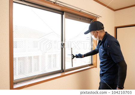 House cleaning male worker cleaning the window House cleaning male worker cleaning the window 104210703