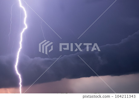 Ray. Lightning storm. Lightning bolt storm. Fork lightning striking. Lightning thunderstorm flash over the night sky. Concept on topic weather, cataclysms (hurricane, Typhoon, tornado, storm). Ray. Lightning storm. Lightning bolt storm. Fork lightning striking. Lightning thunderstorm flash over the night sky. Concept on topic weather, cataclysms (hurricane, Typhoon, tornado, storm). 104211343