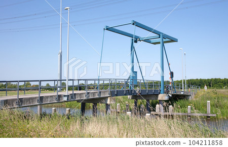 Small automatic drawbridge in the dutch landscape 104211858