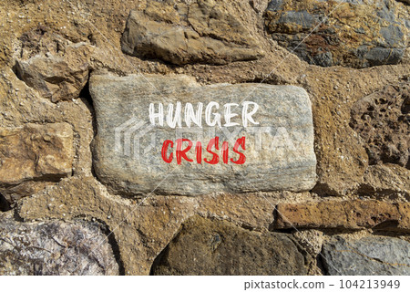 Hunger crisis symbol. Concept words Hunger crisis on beautiful stone on a beautiful stone wall background. Business, support and Hunger crisis concept. Copy space. Hunger crisis symbol. Concept words Hunger crisis on beautiful stone on a beautiful stone wall background. Business, support and Hunger crisis concept. Copy space. 104213949