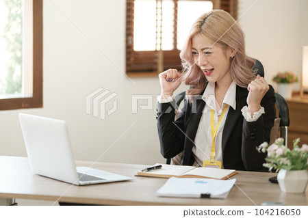 Close up on laptop in office, Asian happy beautiful businesswoman in formal suit work in workplace. Attractive female employee office worker smile. Close up on laptop in office, Asian happy beautiful businesswoman in formal suit work in workplace. Attractive female employee office worker smile. 104216050