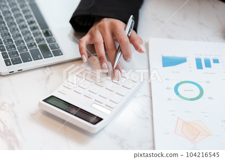 Asian woman working in the beautiful office with coffee computer and mobile phone. Asian woman working in the beautiful office with coffee computer and mobile phone. 104216545
