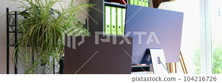 Comfortable office interior with modern laptop and pc 104216726