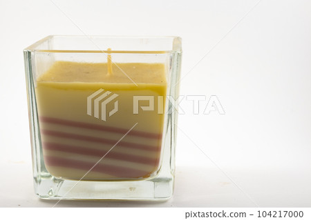 a candle in a glass cup 104217000