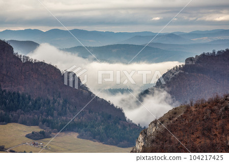 Mountainous landscape with misty valleys in sunset. Mountainous landscape with misty valleys in sunset. 104217425