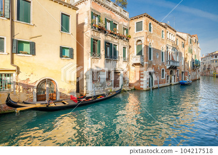 Gondola in a canal of the old town of Venice, Italy. Gondola in a canal of the old town of Venice, Italy. 104217518