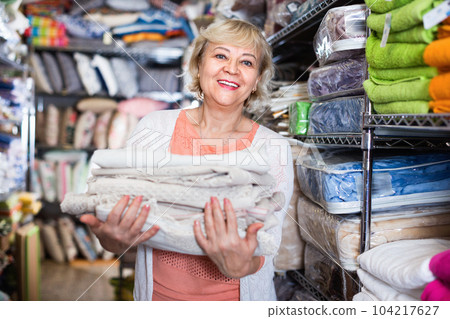 customer female choosing cotton tablecloths in the textile store customer female choosing cotton tablecloths in the textile store 104217627