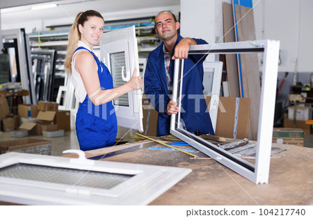 Portrait of smiling two workers assembling pvc windows 104217740