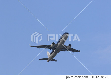 Air travel Passenger plane rising into the blue sky 104218529