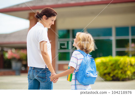 School pick up. Mother and kids after school. School pick up. Mother and kids after school. 104218976