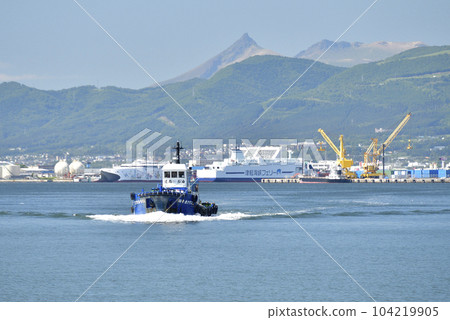 Photographing a small tanker and the scenery of Mt. Komagatake at Hakodate Port in Hakodate City, Hokkaido in early summer 104219905