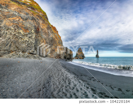 Breathtaking view of rock formations Troll Toes on Black beach Reynisfjara near the village of Vik. 104220184