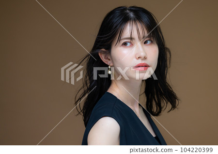 A woman in a black dress A woman in a black dress 104220399