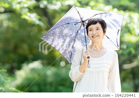 A middle-aged woman with a parasol A middle-aged woman with a parasol 104220441