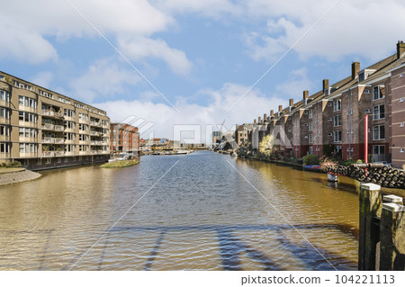 the canal in briney, essex on a sunny day with blue skies and fluffy white clouds over it the canal in briney, essex on a sunny day with blue skies and fluffy white clouds over it 104221113