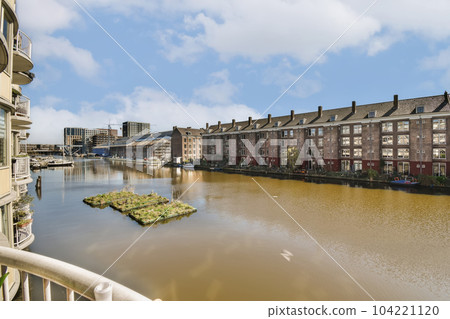 some buildings and water in the middle of an urban area that looks like it's been taken from a bridge 104221120
