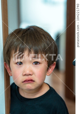 A boy with a crying face A child with a sad expression 104221740