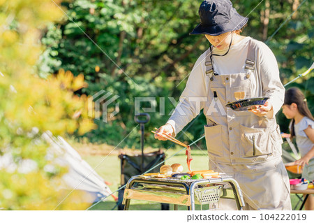 Mom, mother, woman, family, family having a barbecue at the campsite Mom, mother, woman, family, family having a barbecue at the campsite 104222019