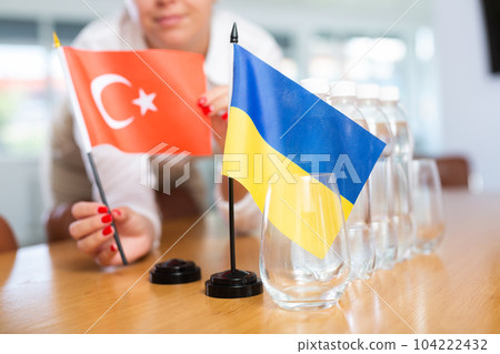 Flags of Ukraine and Turkey placed on negotiating table in meeting room 104222432