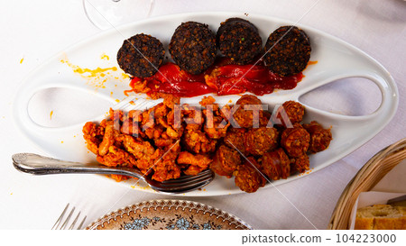 Blood sausage, chorizo, picadillo and baked cherry peppers 104223000