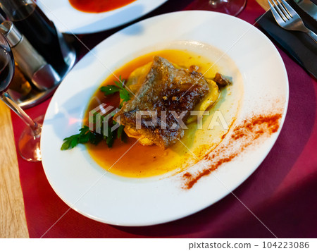 Stewed pork loin in a sauce , served with roasted potatoes Stewed pork loin in a sauce , served with roasted potatoes 104223086