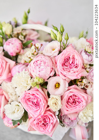 Flower arrangement in Wicker basket. Beautiful bouquet of mixed flowers on a marble table. Floral shop concept . Handsome fresh bouquet. Flowers delivery Flower arrangement in Wicker basket. Beautiful bouquet of mixed flowers on a marble table. Floral shop concept . Handsome fresh bouquet. Flowers delivery 104223634