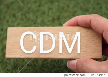 A person holding a building block that says CDM 104223944
