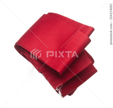 Red Obi fabric Japanese Traditional Komono equipment fly in air with curve. Obi fabric Japanese Traditional Komono around waist is beautiful clothes for ceremony event. White background isolated 104224081
