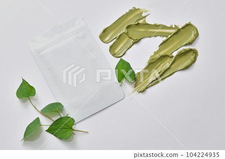 Facial mask package without label displayed with green cosmetic cream. Cosmetic package mock up collection of Fish mint (Houttuynia cordata) extract Facial mask package without label displayed with green cosmetic cream. Cosmetic package mock up collection of Fish mint (Houttuynia cordata) extract 104224935