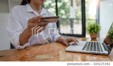 Hands holding credit card and using laptop. Online shopping Hands holding credit card and using laptop. Online shopping 104225392