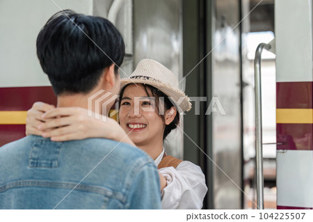 positive girlfriend hugging pleased man while locating near train positive girlfriend hugging pleased man while locating near train 104225507